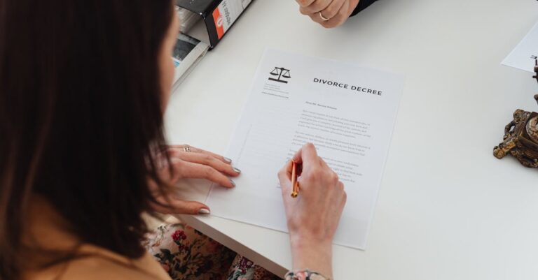 a-person-signing-a-divorce-decree-document-with-focus-on-hands-and-paper - Granholm & Gynac, LLC